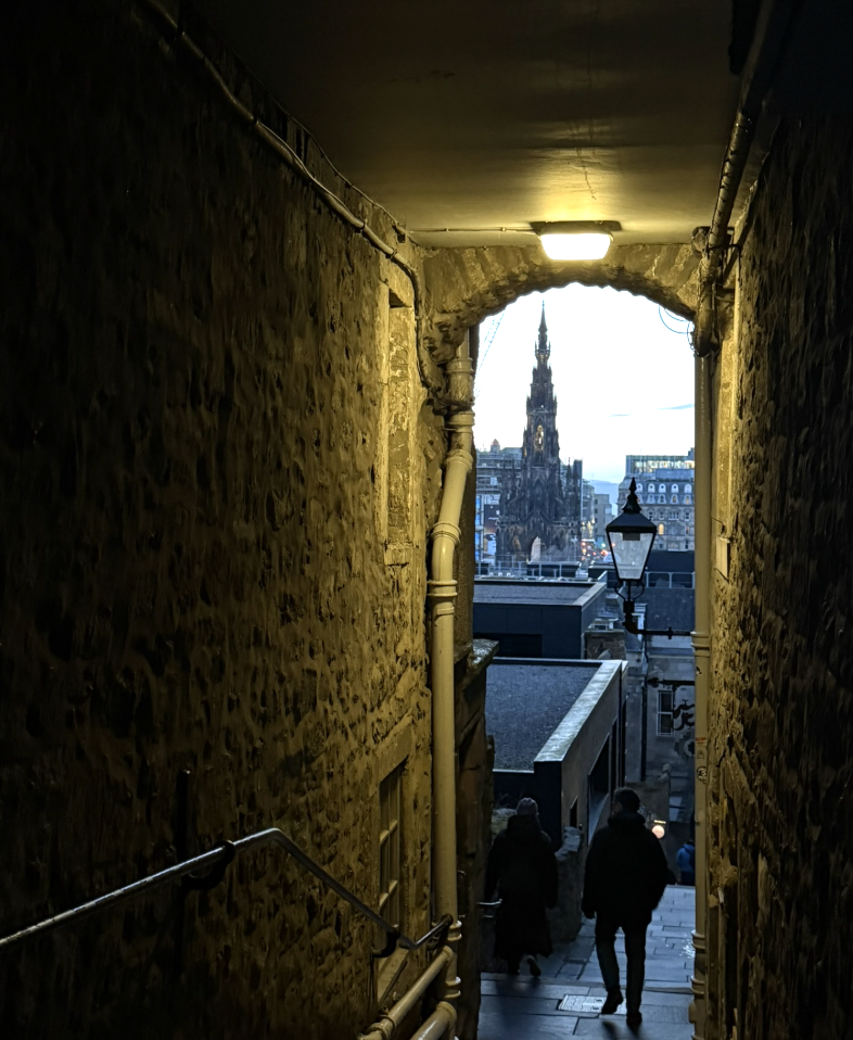 The Scott Monument framed by a narrow Edinburgh close