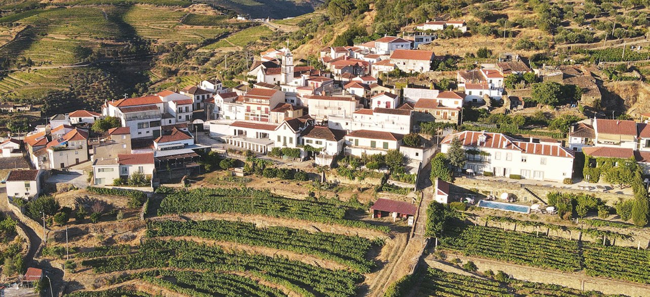 Whitewashed Portuguese village above terraced hills