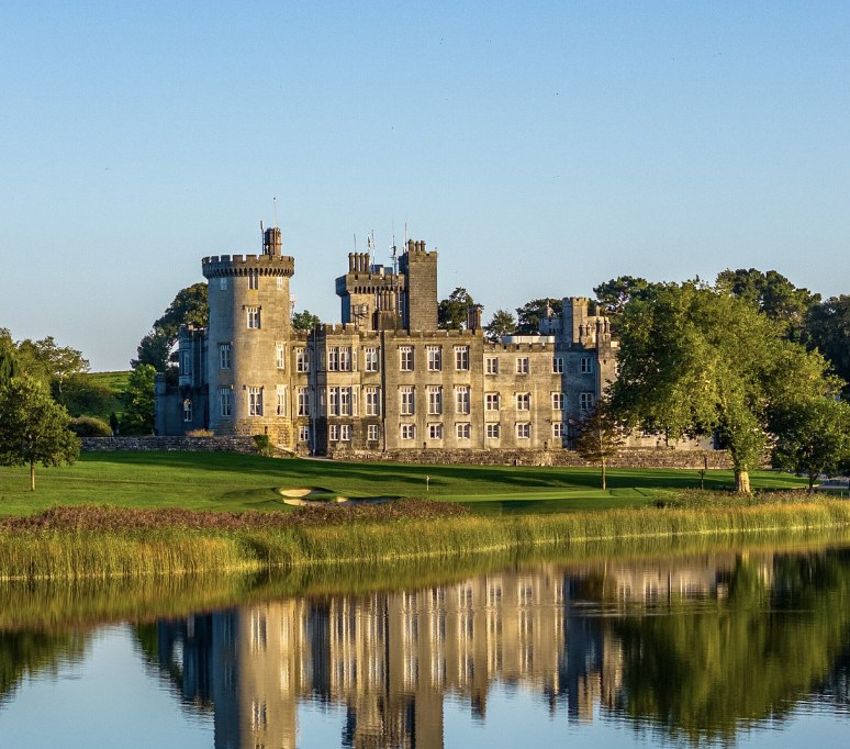 Dromoland Castle reflected in its lake beside the golf course