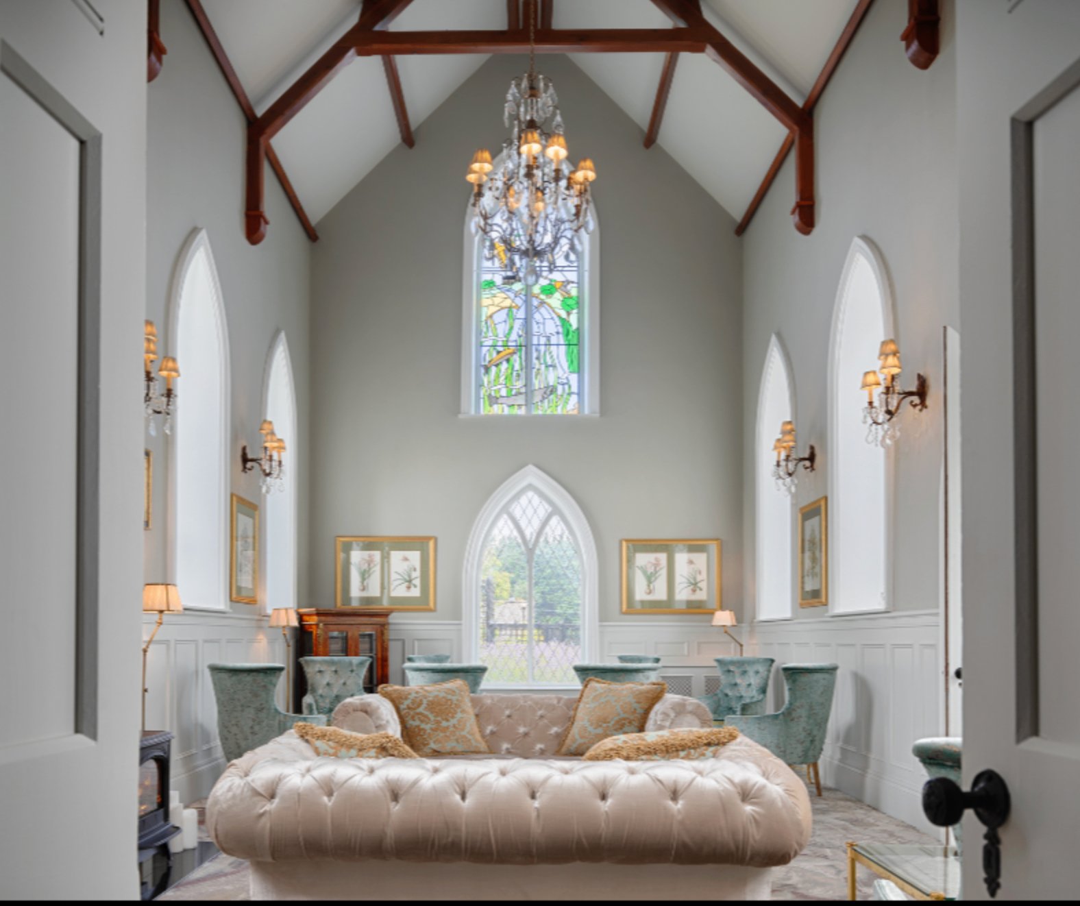 The restored abbey lounge with stained glass and chandelier