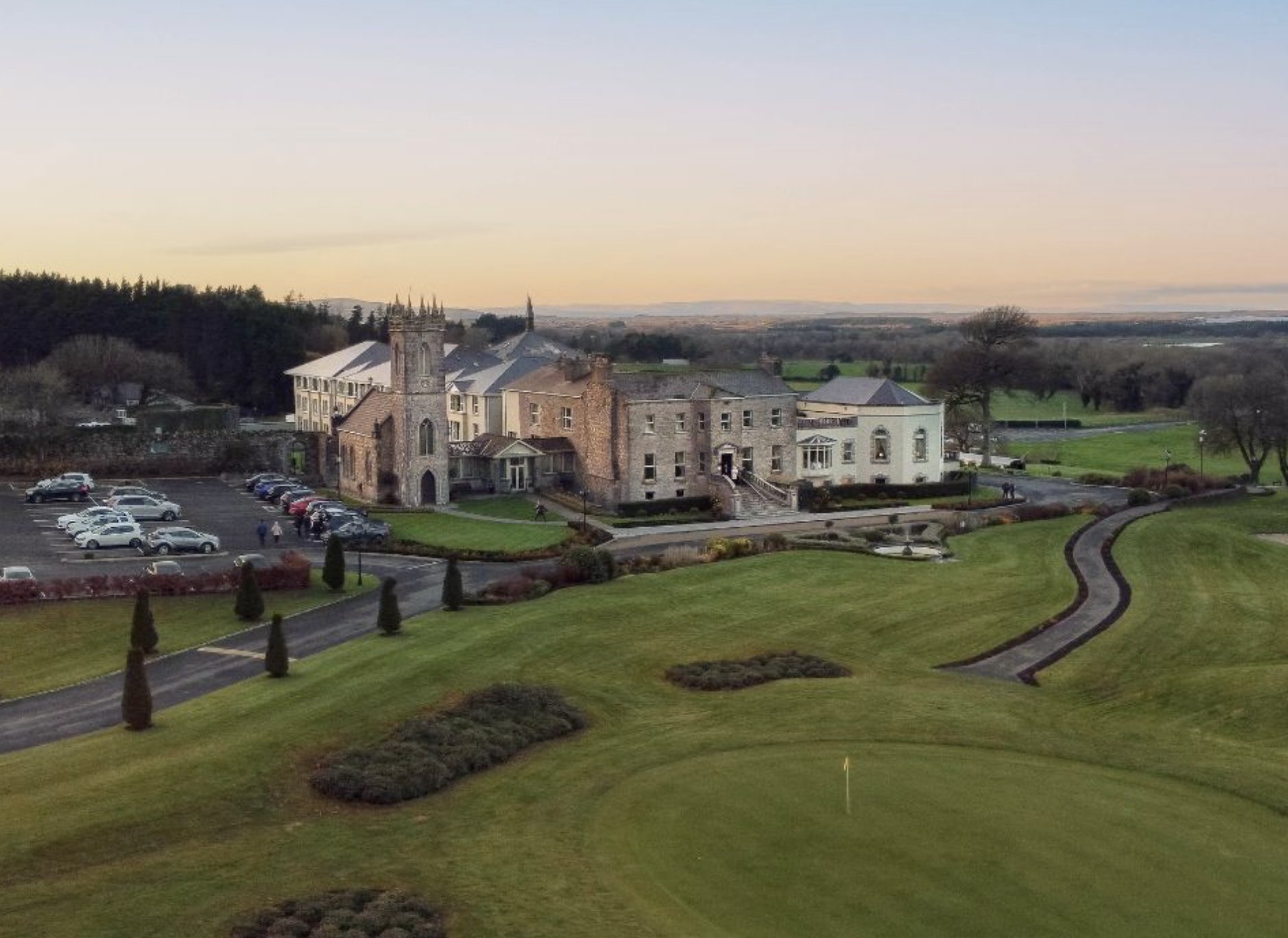 Glenlo Abbey Hotel and its golf course at sunset