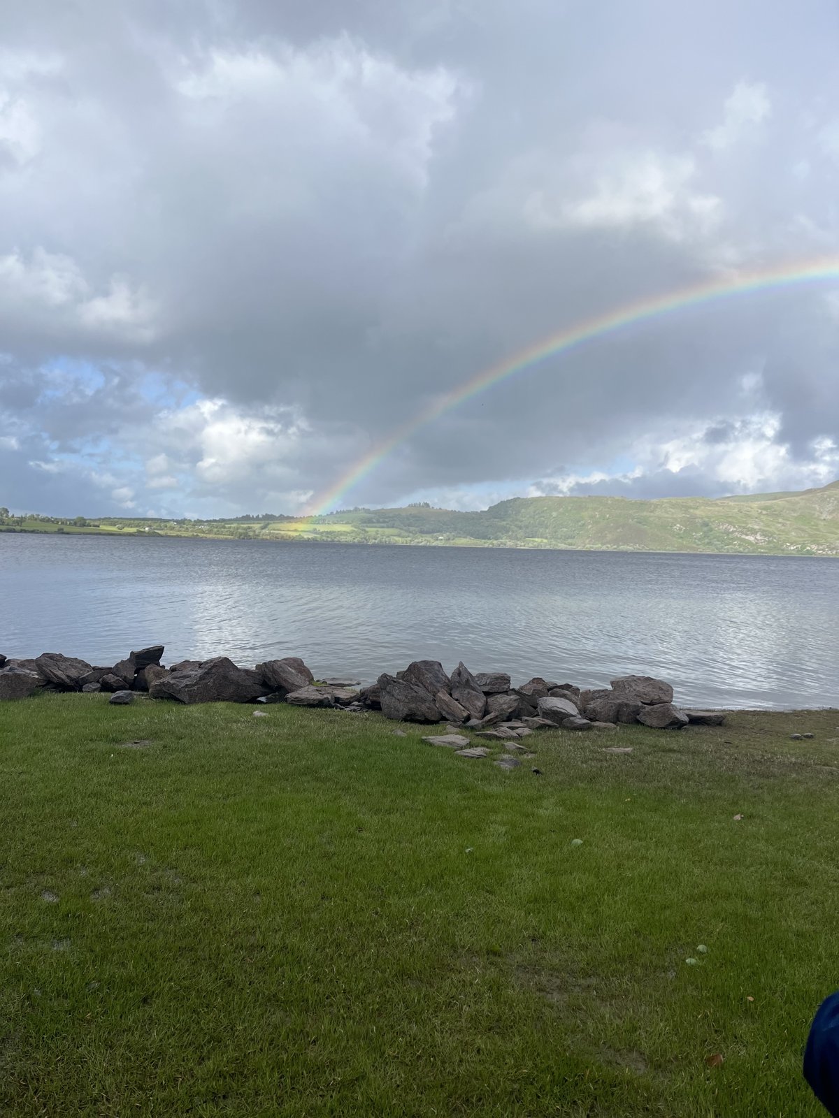 A rainbow over a lake in the Irish countryside