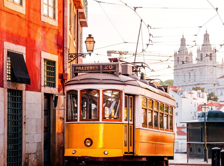 Yellow Lisbon tram on a hillside street