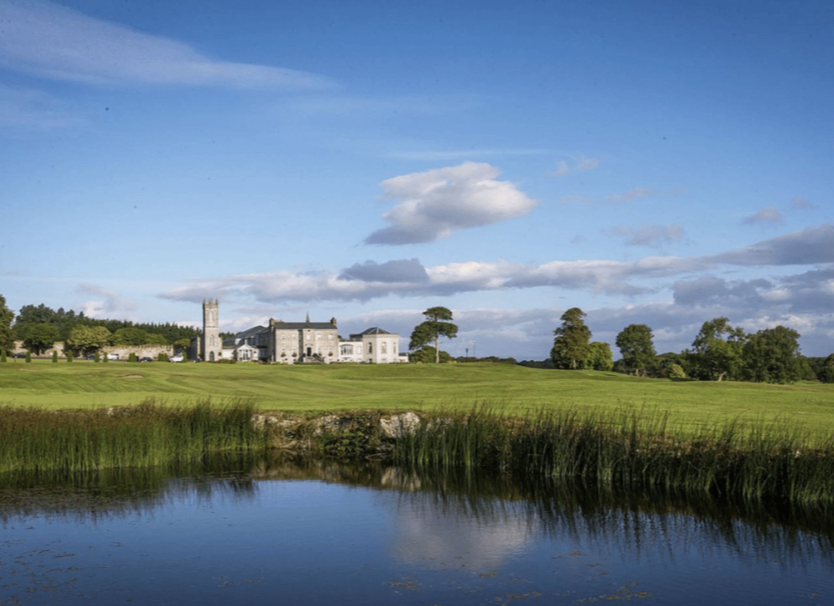 Glenlo Abbey across the lake and green fairways