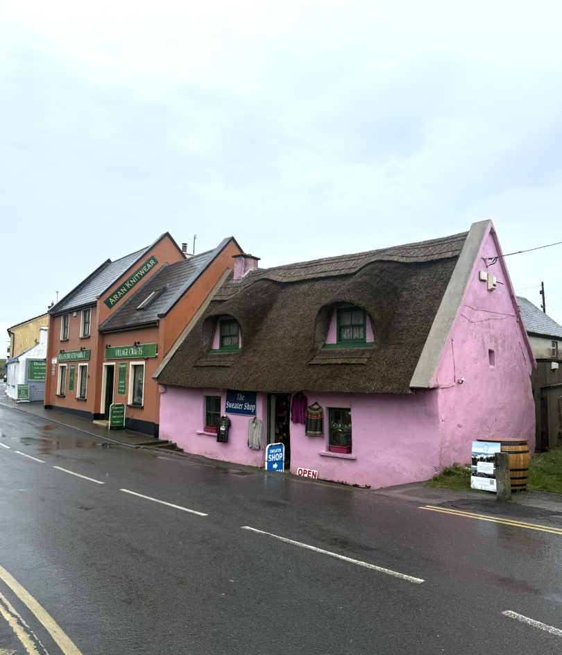 Pink thatched-roof sweater shop and Aran knitwear store in Doolin